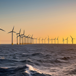 **Offshore Wind Farm at Sunset:** A stunning view of a modern offshore wind farm near the Portuguese coast at sunset. Golden light reflecting on the turbines and the ocean, with a few traditional fishing boats in the distance. Include realistic details like seabirds and subtle wave patterns. Focus on the beauty and promise of renewable energy.